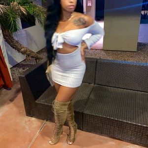 Thigh high beige tie up boots.